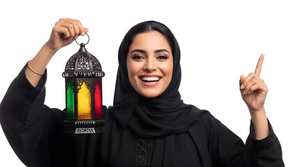 A happy Arab woman in a black hijab holds a colorful lantern and points upwards with her index finger.