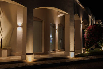 Modern building exterior at night with architectural lighting