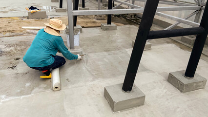Workers are installing reinforced plastic mesh for waterproofing on roofs, rubber roofing, or rubber coatings.