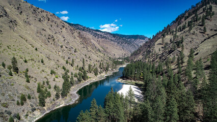 drone photo of Salmon River Canyon upstream from Riggins ID with white sandy beaches and beautiful clear reflection of the canyon walls and blue sky