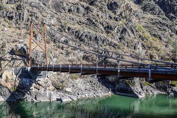 Photo of the vintage Manning Bridge over the Salmon River upstream from Riggins Id  this historical cable suspension bridge has been replaced