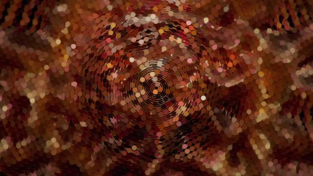 A complex, shimmering abstract animation featuring a "bubble wrap" or mosaic texture. Warm tones of gold, amber, and brown swirl in a circular motion with a bokeh-like glitter effect.
