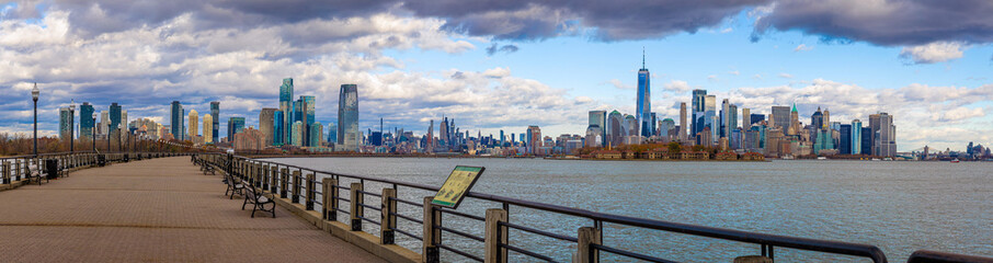Panoramic view of Lower Manhattan skyline from Jersey City waterfront promenade