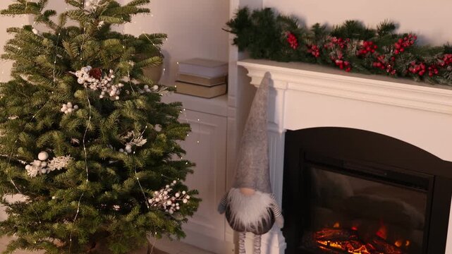 Beautiful Christmas tree and decorative gnome near fireplace at home