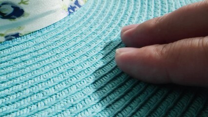 Woman summer blue straw hat texture, closeup view of woven turquoise material, macro perspective highlighting artisan yarn work in fabric