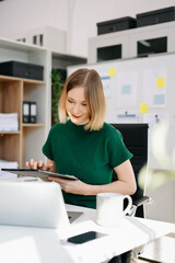 Smiling business woman working on a laptop in a bright modern office. remote work, and professional lifestyle.