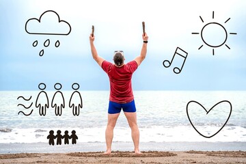 A man in red shirt and blue shorts stands barefoot on a beach with arms raised while surrounded by whimsical doodles including sun, rain, music notes, and figures