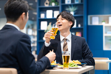 飲食店でビールを飲む若いビジネスマン