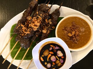 traditional indonesian beef satay served with peanut sauce and sweet soy sauce