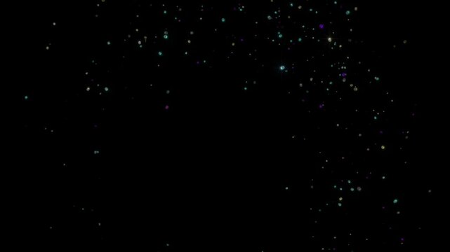 Burst of colorful particles that form a circular ring before scattering and fading away into the dark.