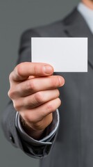 Businessman hand presenting blank white business card for corporate contact and networking