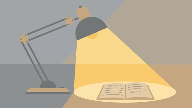 Desk lamp illuminating an open book under warm light.