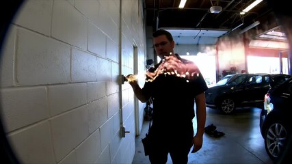 Electrician using a voltage tester in a auto repair shop, checking the power outlets for electrical problems