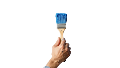 A hand holding a paintbrush with bright blue paint against a black background