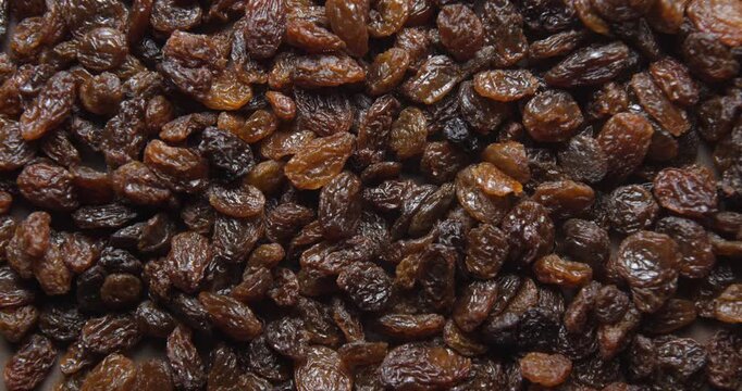 Black raisins close up studio shot over rotating
