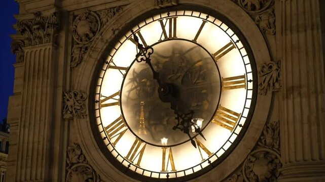 Ornate Illuminated Clock Face with Roman Numerals Ticking at Night - Parisian Time Lapse and Deadline Concept.