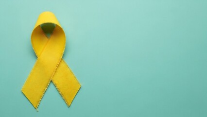 Symbol of hope: a bright yellow awareness ribbon against a calming teal background