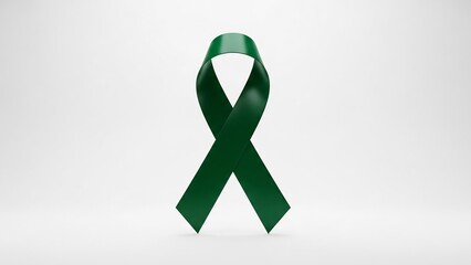 Symbol of hope: a deep emerald green awareness ribbon with a glossy satin texture against a neutral background