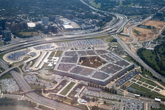 Aerial view of the Pentagon complex with surrounding roads, parking and greenery. g.