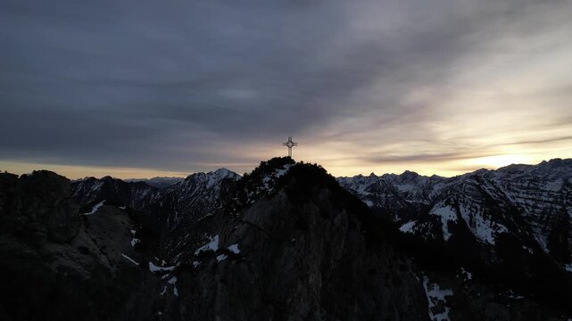 Sunrise in the mountain with beatiful view to the cross on the top of the mountain,