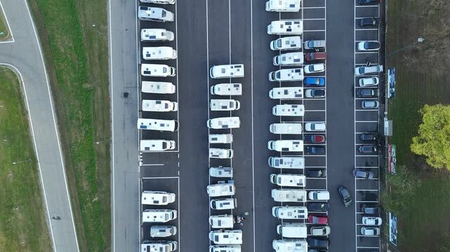 Drone perspective of organized rows of visiting motorhomes at Piazzale Atleti Azzurri d'Italia, temporary logistical hub supporting the thousands of attendees at Cremona's annual Festa del Torrone