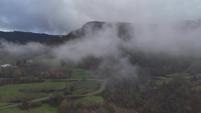 Val Tolla highlands near Castelletto and Vernasca, capturing a dramatic thermal inversion over the ancient beech forests and the Romanesque silhouette of the Sant'Andrea Church.
