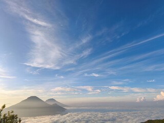 Dramatic mountain landscape covered with mist and clouds, creating a mysterious and atmospheric natural scenery. Perfect for nature, adventure, and cinematic background use © Danni