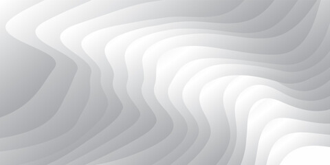 Smooth flowing white waves create an abstract design on a grey background.