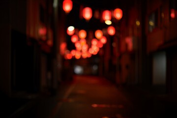 Blurred view of traditional red lanterns illuminating a narrow street at night, creating a festive and mysterious atmosphere for exploration
