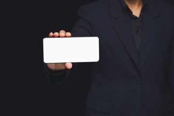 Business person holding smartphone with blank white screen mockup.