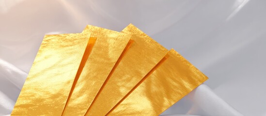 Golden Fabric Fanned Out on White Silk.