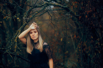 Dark Princess wearing a Crown feeling Melancholic Outdoors. Mysterious queen contemplating her life decisions feeling lost
