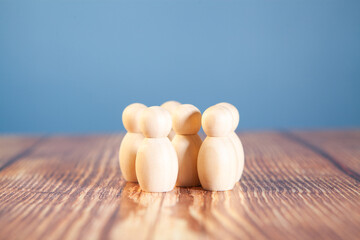 wooden figures of people stand on a wooden table. business concept