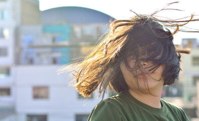 Preteen girl with messy hair covering eyes and forehead. 