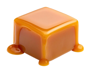 Isolated cube of golden, dripping confection on a black background