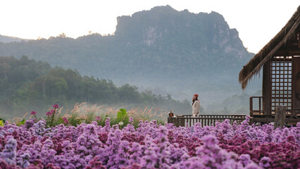 Portrait image of a woman in a beautiful Lavender flower field with mountain in background