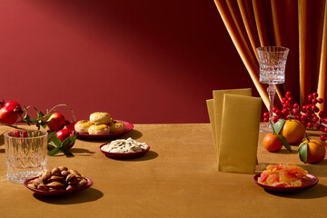 Front view of Lunar New Year setup with traditional snacks, fruits, and decorative fabrics. Red and yellow tone, clean background suitable for branding, add text and display product