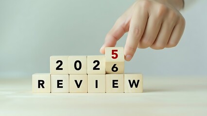 Hand changing wooden blocks to review the year 2026