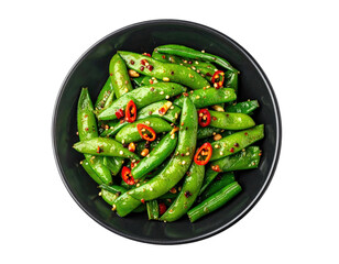 Top-down shot of vibrant green snow peas in a dark bowl with red peppers