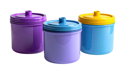 Three colorful canisters with lids, isolated on a black background