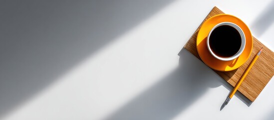 A top-down view showcases a cup of coffee on a saucer, resting on a wooden board, accompanied by a pencil, all set against a white surface with shadows
