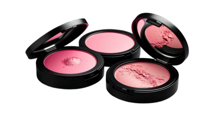 Three pink powder compacts, open and closed, on a dark background