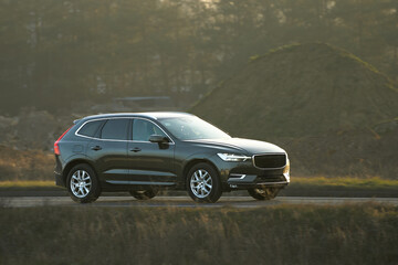 luxury car driving during golden hour