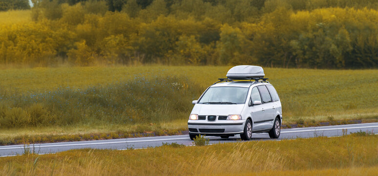 Travel SUV with Cargo Box Driving Outdoors