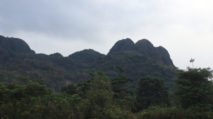 a vast field with grass and a beautiful mountain backdrop