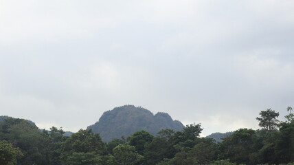Rocks are arranged on the edge of the beach, the sea water is calm