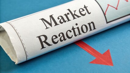 Market reaction to news shown with newspaper headline and red downward arrow on blue background, indicating negative sentiment