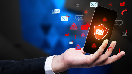 Business hand holds a cellphone that displays a security shield icon, email icons, with notification and alert icons around it. Concept of Information Overload