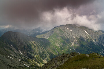 Beautiful alpine scenery, pristine glacier lake, rocks and spring flowers in the Transylvanian Alps in  early summer