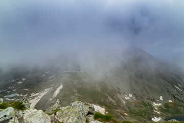 Beautiful alpine scenery, pristine glacier lake, rocks and spring flowers in the Transylvanian Alps in  early summer